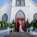 couple poses outside of church after wedding